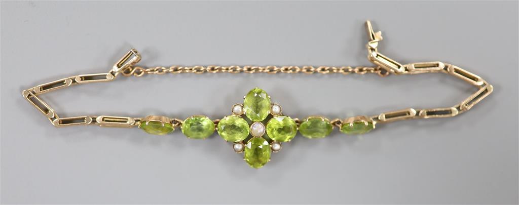 A late Victorian 9ct, peridot and seed pearl cluster set bracelet(adapted), approx. 16.5cm, gross 9 grams.